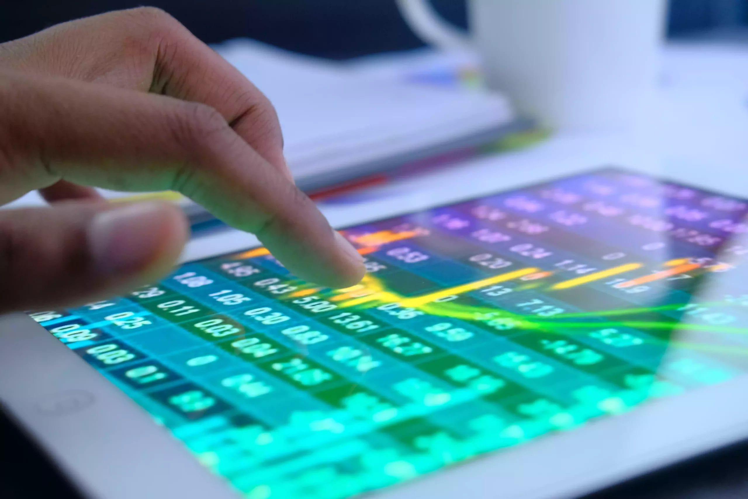 close-up-of-man-hand-analyzing-stock-market-chart